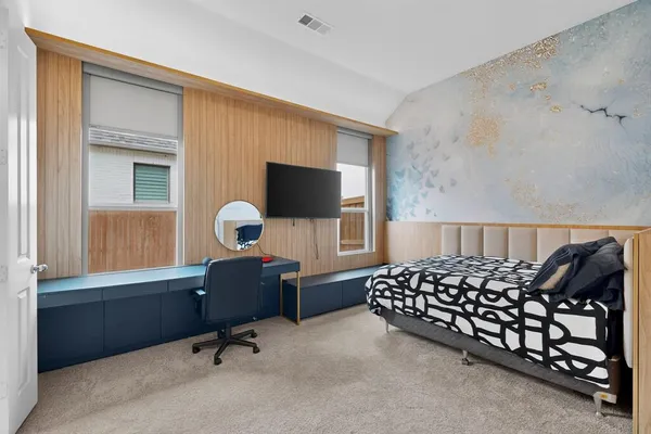 a bedroom with a bed and a window