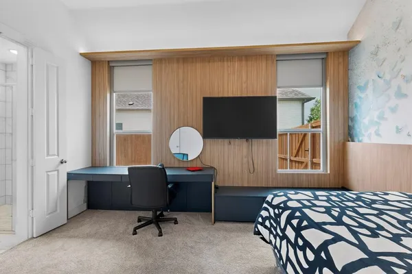 a bedroom with a bed and a flat screen tv