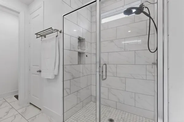 a bathroom with a shower and a glass door