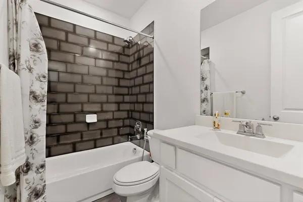 a bathroom with a toilet a sink and bathtub