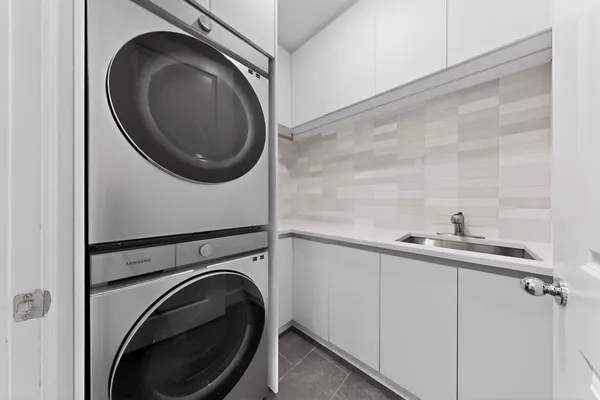 a utility room with sink dryer and washer