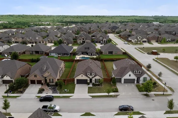 an aerial view of houses with a street