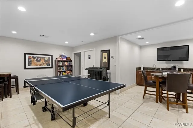 a kitchen with stainless steel appliances a table and chairs in it