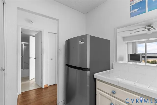 a kitchen with a refrigerator and a sink