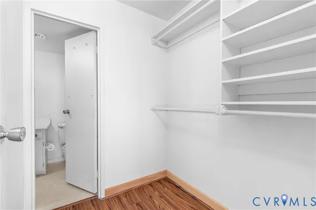 a view of walk in closet with empty racks