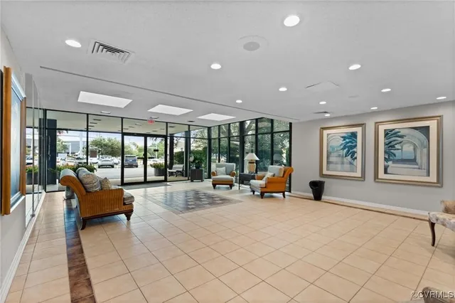 a lobby with furniture and large windows