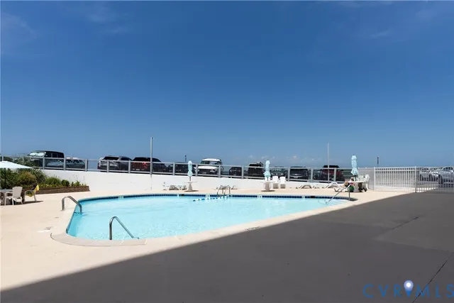 a view of a swimming pool and an outdoor seating