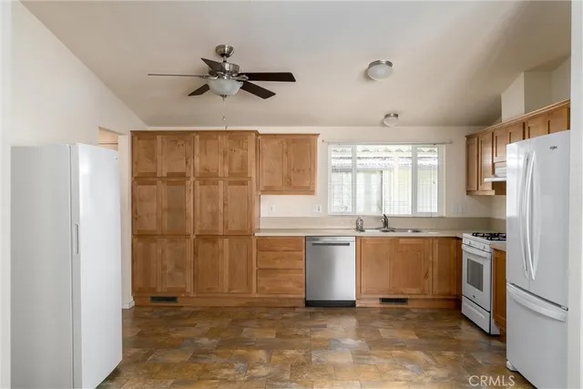 a kitchen with a refrigerator a sink and dishwasher