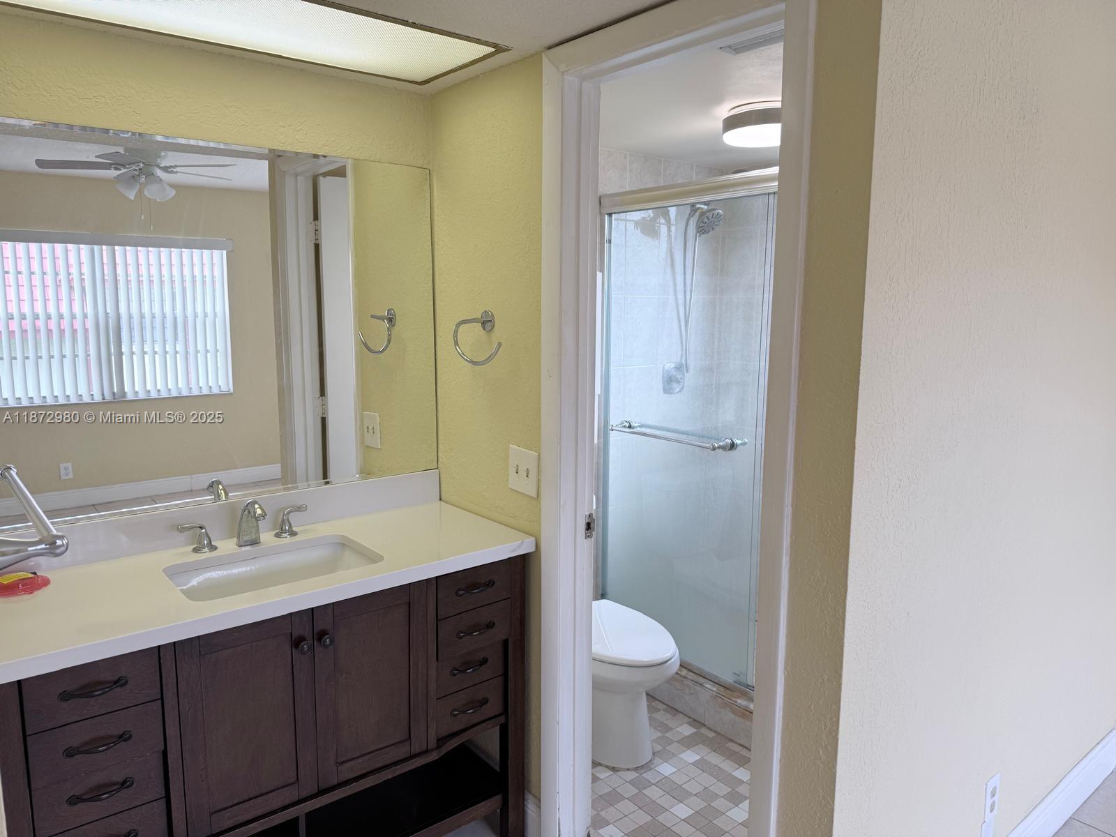 3224 Northwest 103rd Terrace, Unit 205B Coral Springs, FL 33065 - Photo 15 of 21 a bathroom with a sink a toilet and shower