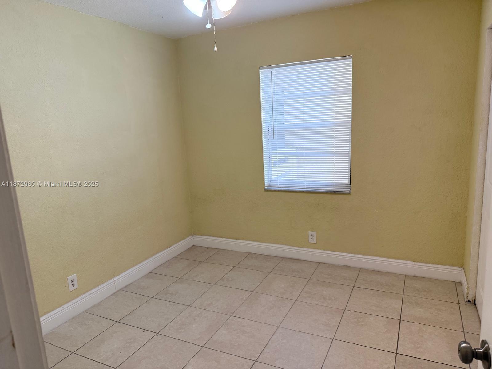 3224 Northwest 103rd Terrace, Unit 205B Coral Springs, FL 33065 - Photo 16 of 21 an empty room with a window