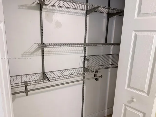 a bathroom with a sink mirror and shower