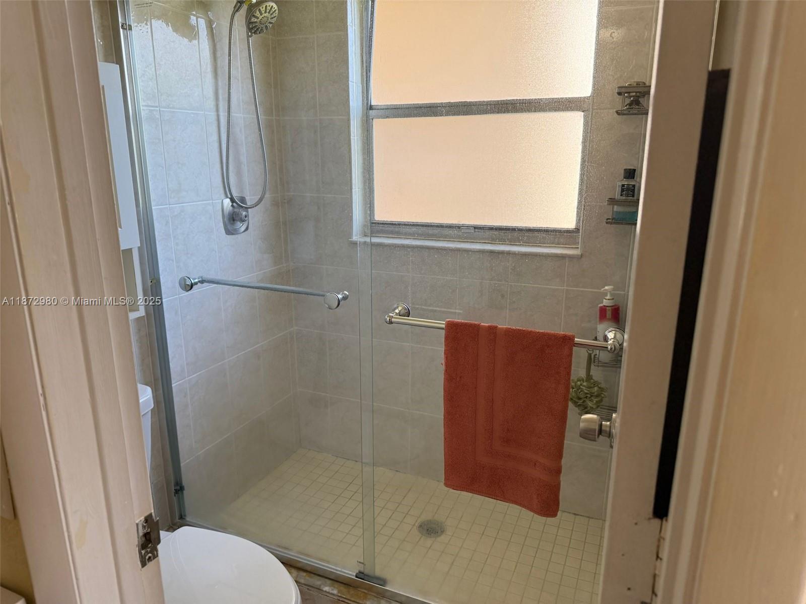 3224 Northwest 103rd Terrace, Unit 205B Coral Springs, FL 33065 - Photo 9 of 21 a bathroom with a shower and toilet