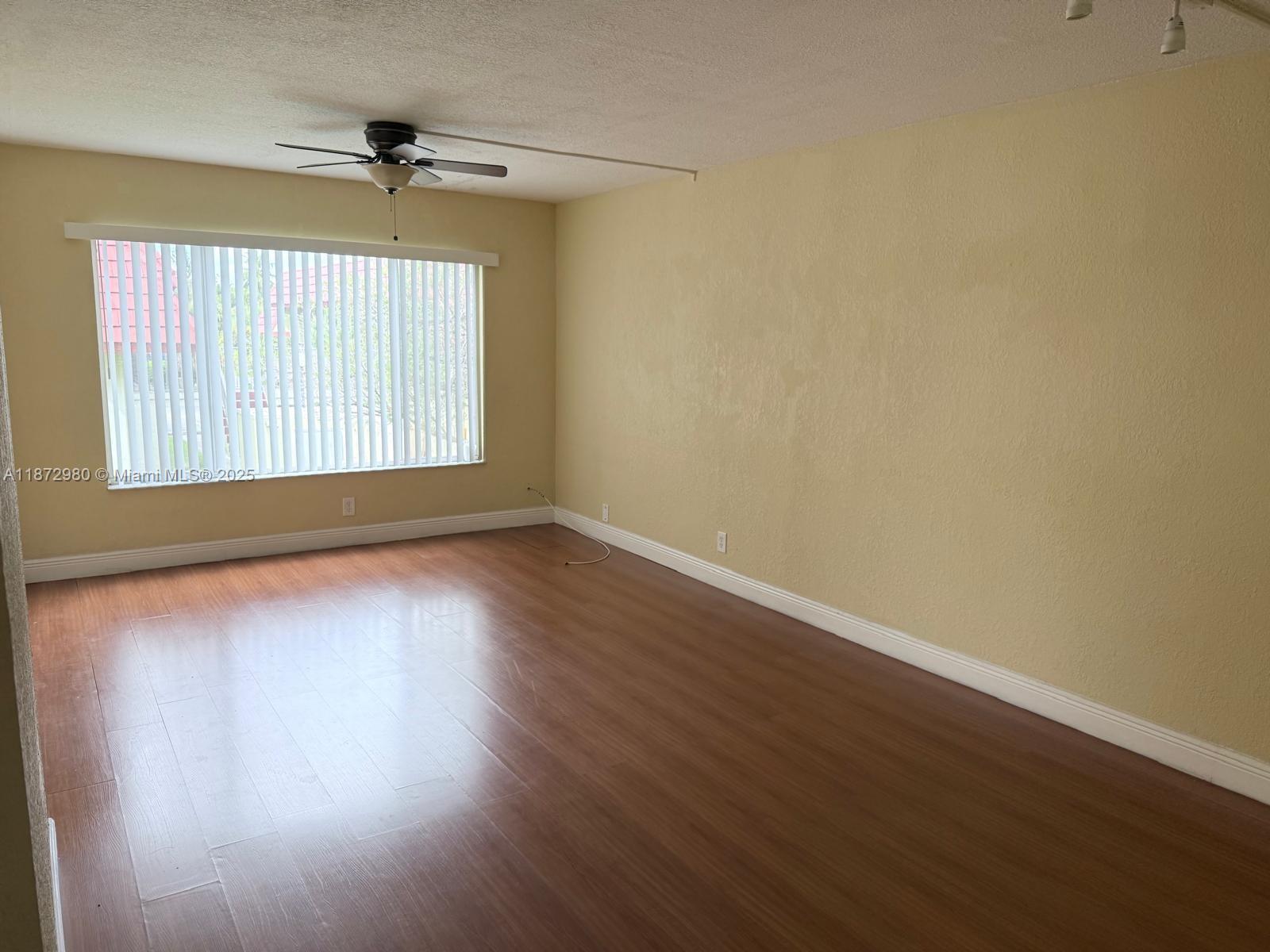 3224 Northwest 103rd Terrace, Unit 205B Coral Springs, FL 33065 - Photo 10 of 21 a view of wooden floor and windows in a room