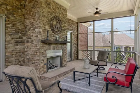 a living room with fireplace furniture and a floor to ceiling window