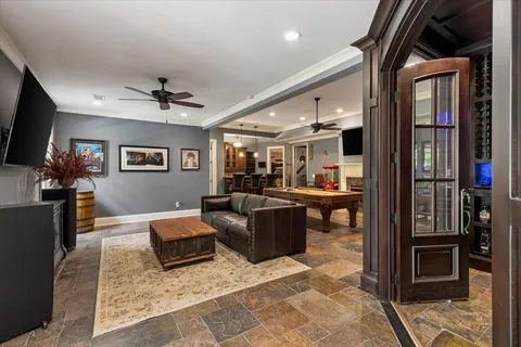 a living room with furniture a flat screen tv and a fireplace