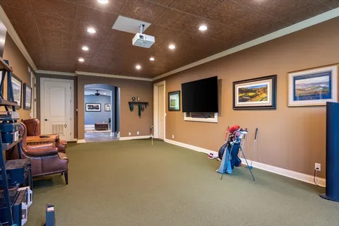 a dining room with stainless steel appliances kitchen island granite countertop a table chairs and a sink