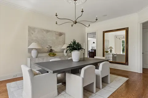 a dining room with furniture and wooden floor