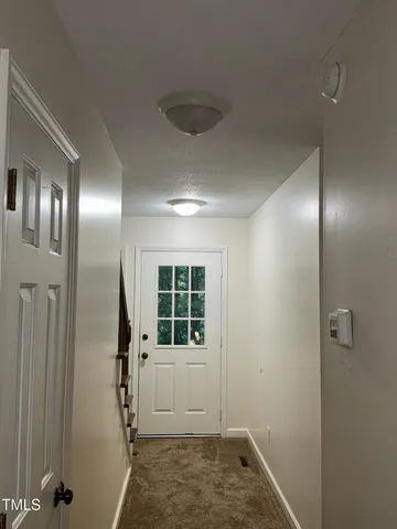 a view of hallway with shower and wooden floor