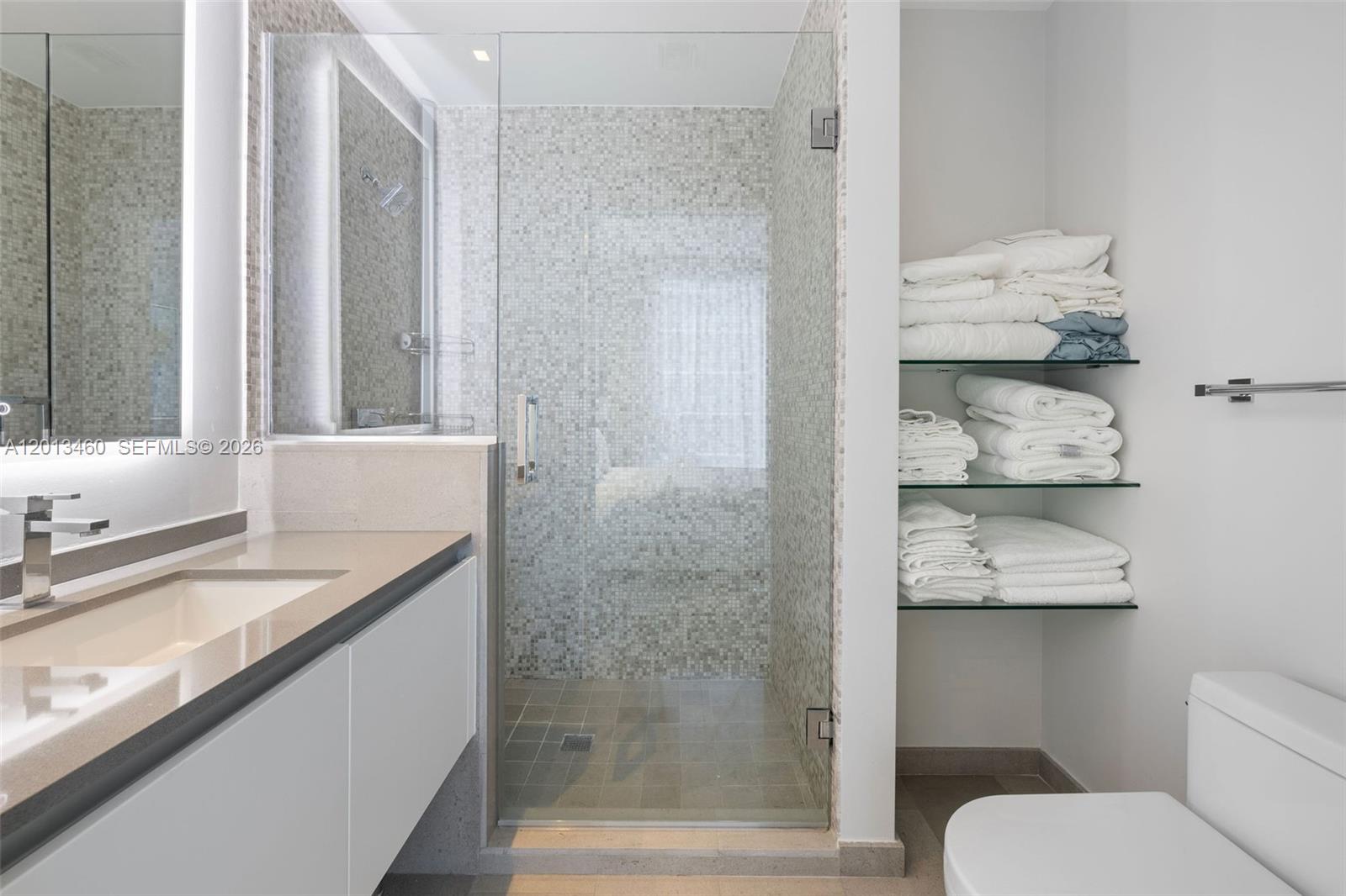 88 Southwest 7th Street, Unit 1201 Miami, FL 33130 - Photo 11 of 39 a bathroom with a granite countertop sink a toilet and shower