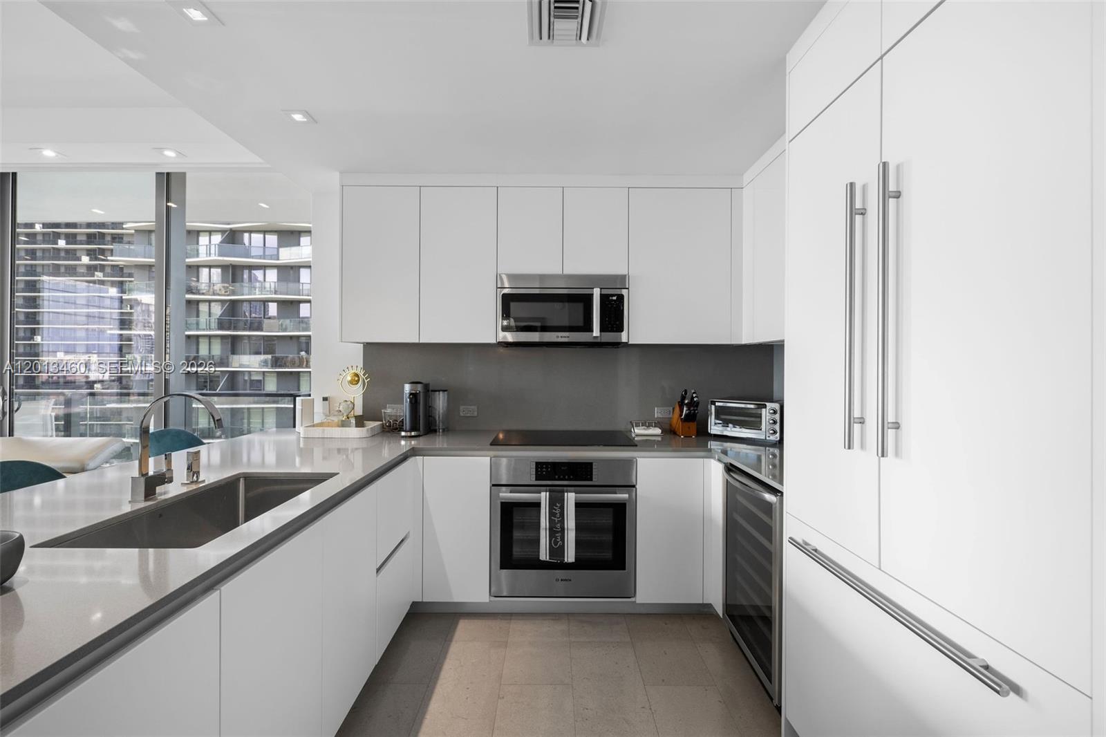 88 Southwest 7th Street, Unit 1201 Miami, FL 33130 - Photo 21 of 39 a kitchen with a sink and a stove top oven