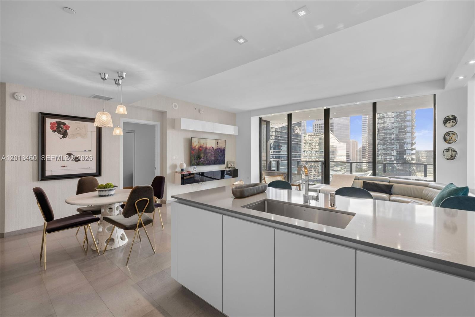 88 Southwest 7th Street, Unit 1201 Miami, FL 33130 - Photo 22 of 39 a dining room with furniture and large windows