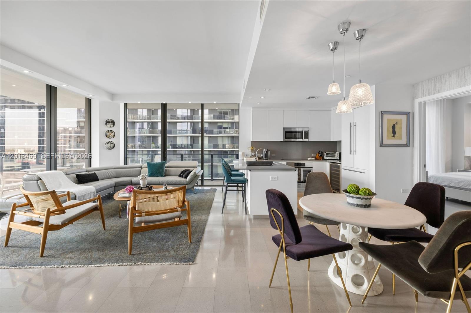 88 Southwest 7th Street, Unit 1201 Miami, FL 33130 - Photo 25 of 39 a living room with furniture and a dining table with kitchen view