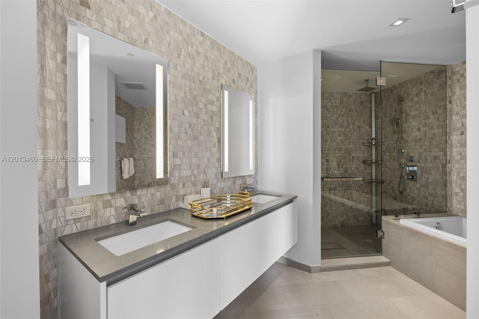 88 Southwest 7th Street, Unit 1201 Miami, FL 33130 - Photo 26 of 39 a bathroom with a sink and a mirror with bathtub