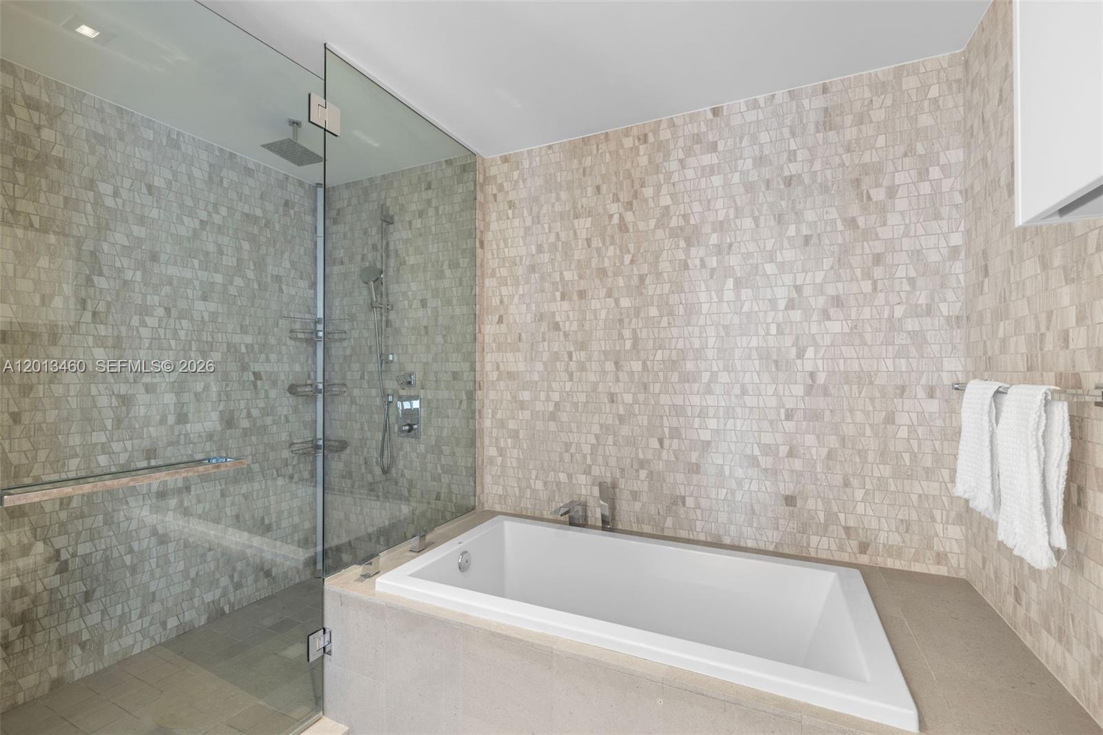 88 Southwest 7th Street, Unit 1201 Miami, FL 33130 - Photo 27 of 39 a bathroom with a bathtub and a shower