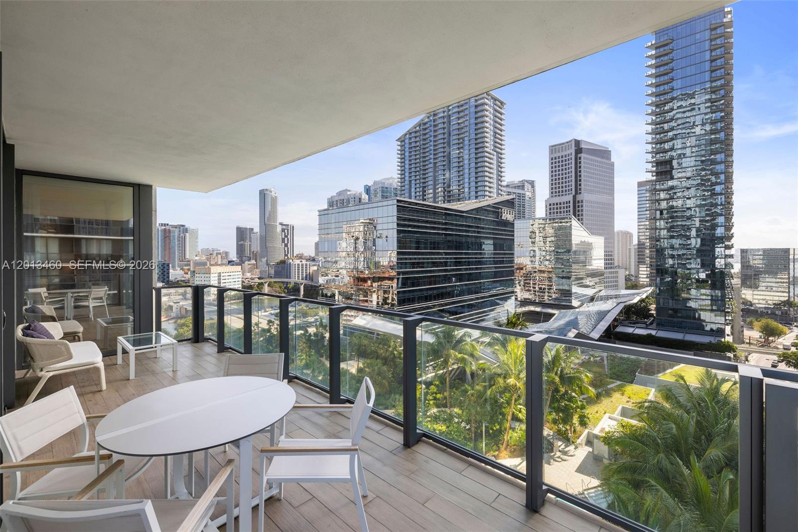 88 Southwest 7th Street, Unit 1201 Miami, FL 33130 - Photo 3 of 39 a balcony with table and chairs