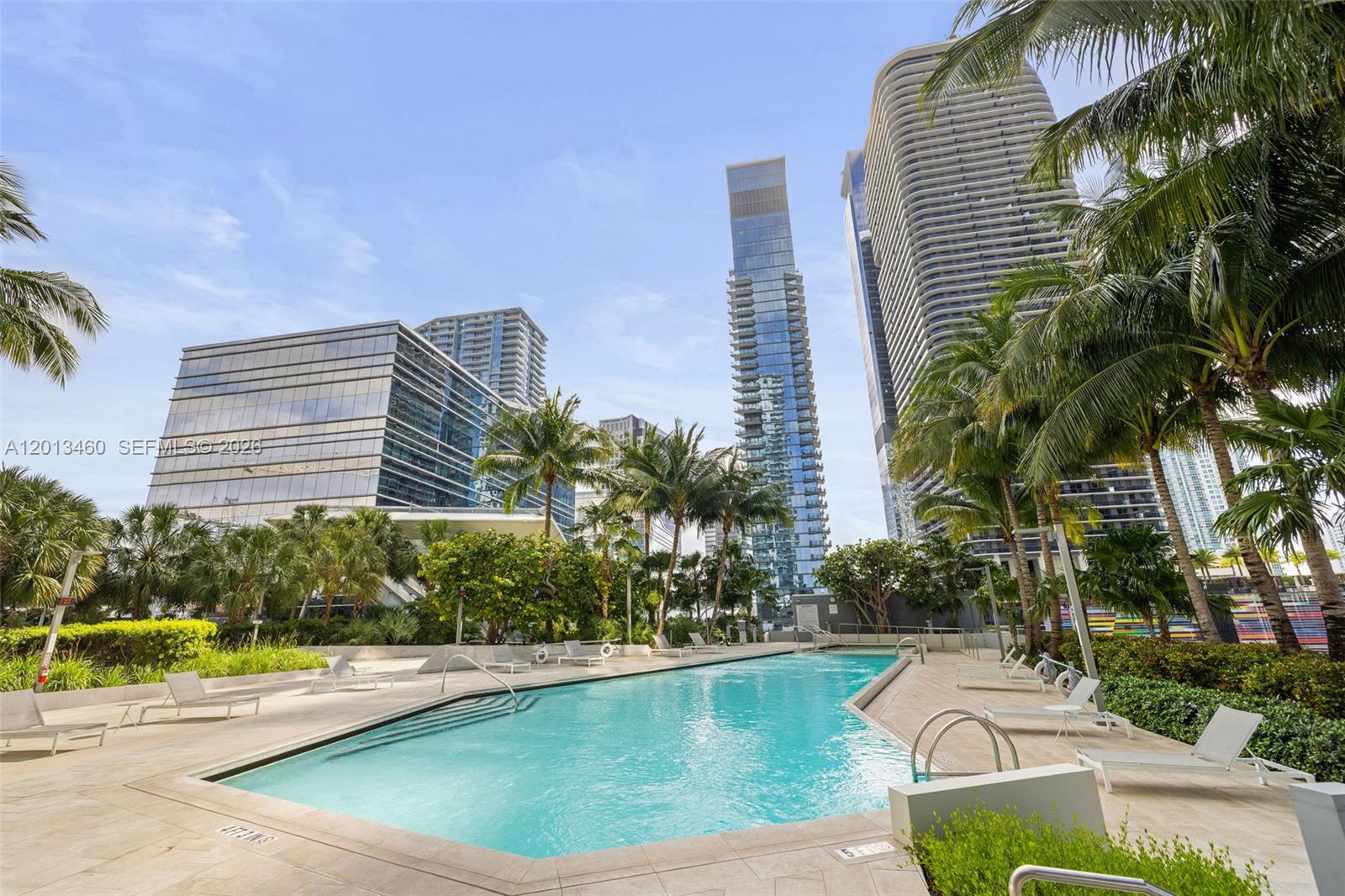 88 Southwest 7th Street, Unit 1201 Miami, FL 33130 - Photo 32 of 39 a view of a swimming pool with chairs