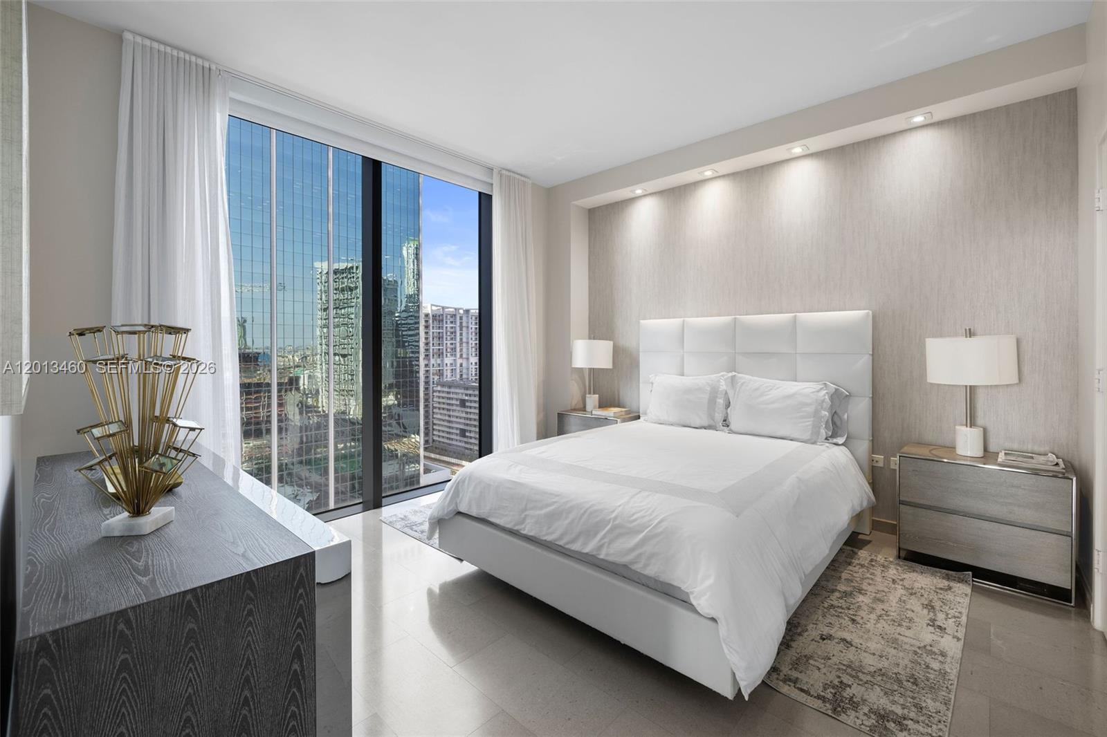 88 Southwest 7th Street, Unit 1201 Miami, FL 33130 - Photo 8 of 39 a bedroom with a large bed and a window