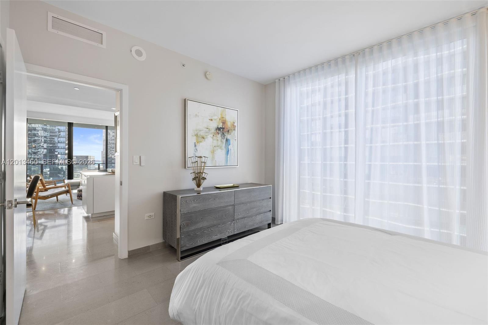 88 Southwest 7th Street, Unit 1201 Miami, FL 33130 - Photo 9 of 39 a bedroom with a bed and a chair