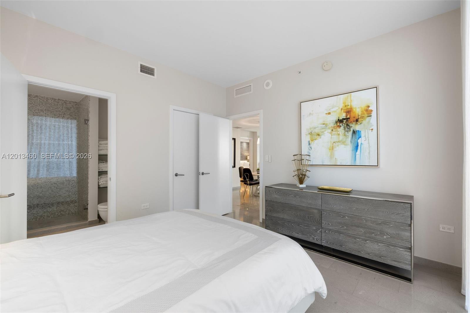88 Southwest 7th Street, Unit 1201 Miami, FL 33130 - Photo 10 of 39 a bedroom with a bed and a dresser