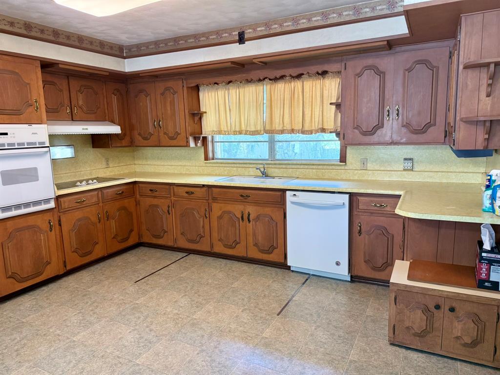 1537 Burns City Road Gainesville, TX 76240 - Photo 17 of 27 a kitchen with a sink and cabinets