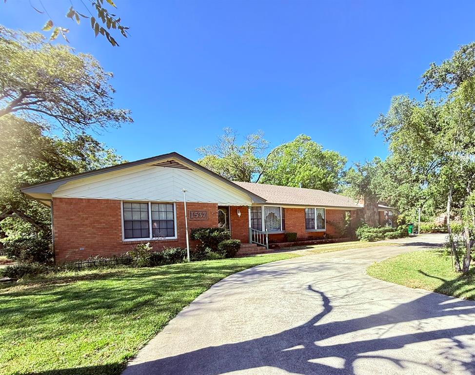 1537 Burns City Road Gainesville, TX 76240 - Photo 2 of 27 a front view of a house with a yard and trees