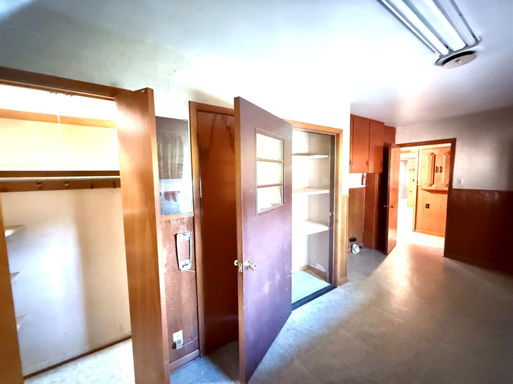 1537 Burns City Road Gainesville, TX 76240 - Photo 23 of 27 a view of a hallway with wooden floor and cabinet
