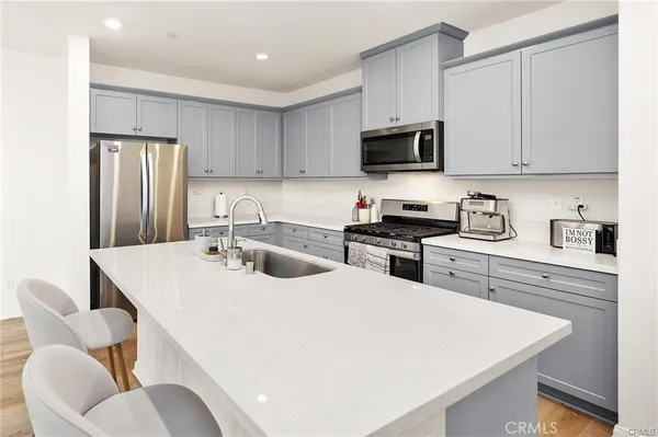 a kitchen with stainless steel appliances granite countertop a sink a microwave and cabinets