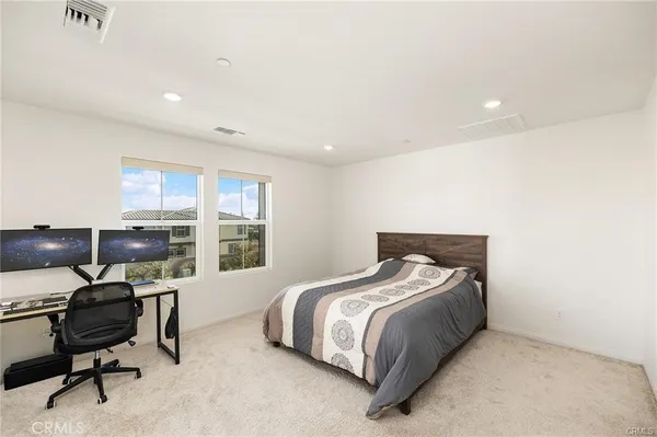 a bedroom with a bed and a desk