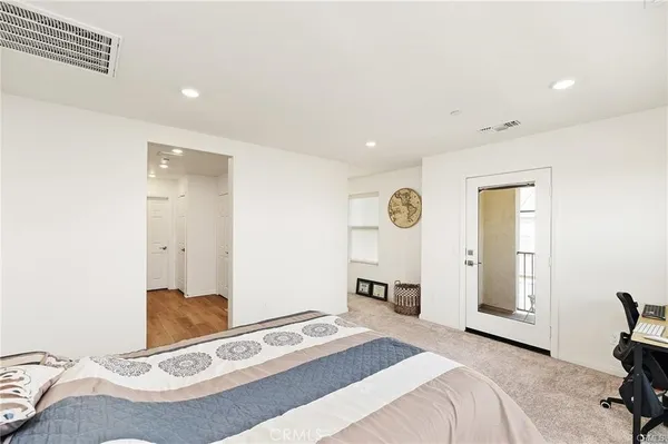 a bedroom with a bed and a table with chair