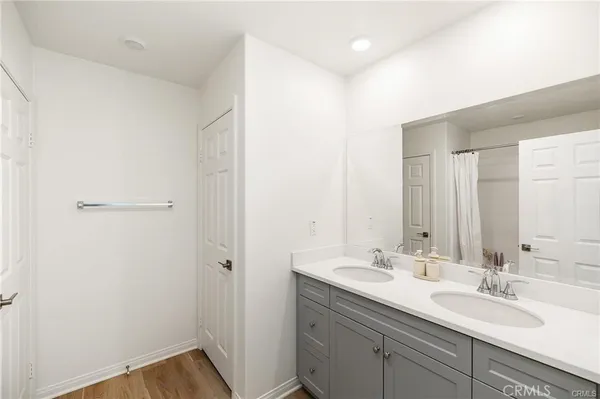 a bathroom with 2 sink and a mirror