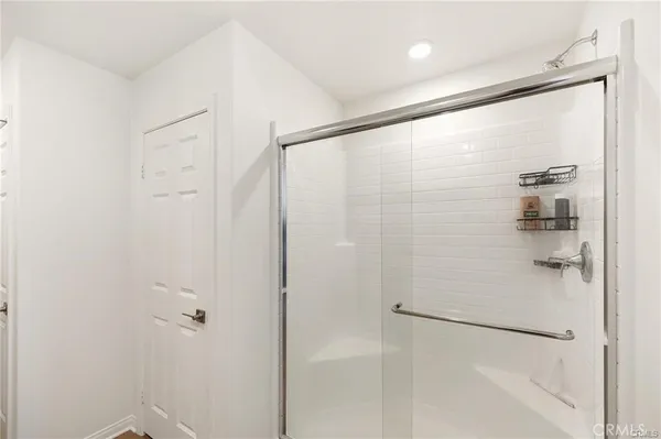 a bathroom with a glass shower door