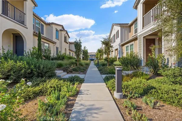 a view of a pathway with a garden