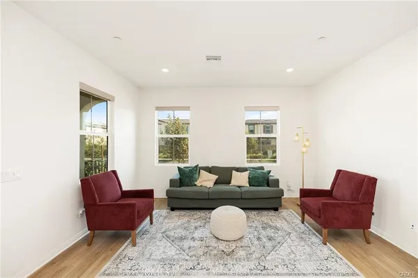 a living room with furniture and a large window
