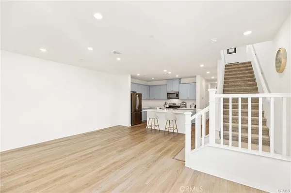 a view of kitchen with wooden floor and electronic appliances