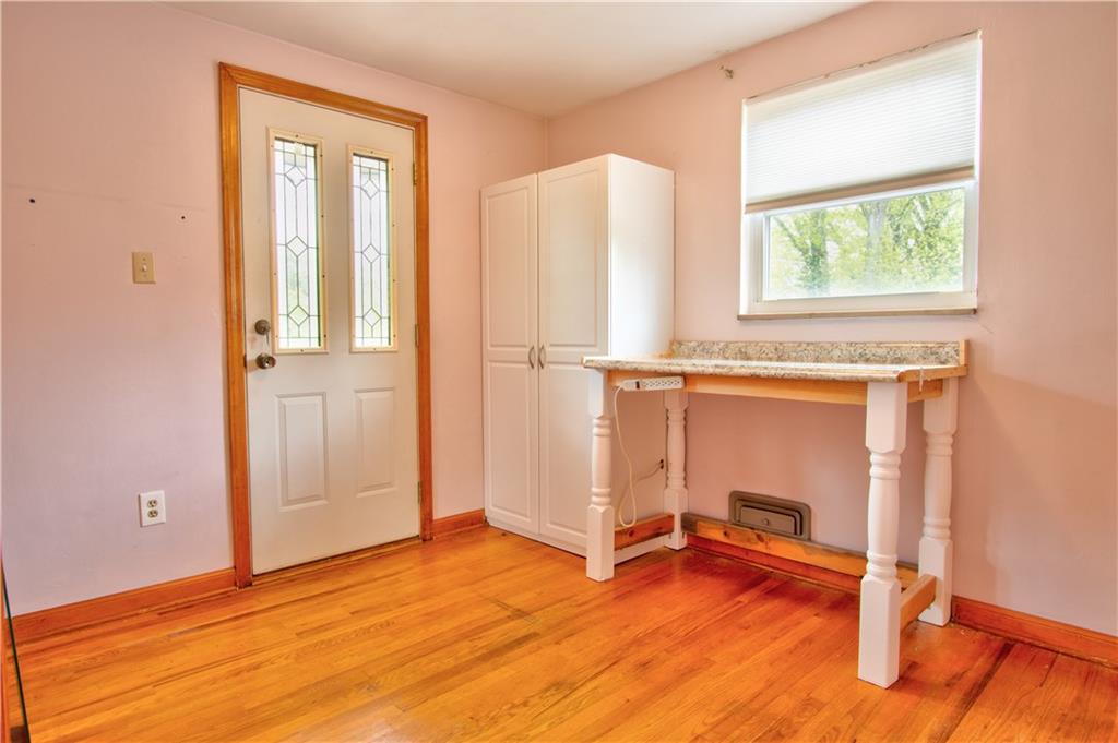 2076 Borland Road Pittsburgh, PA 15243 - Photo 11 of 24 Main level Bedroom...may be used as office, playroom, nursery. Hardwood floors, closet, access to rear deck. Built-in armoir and table/desk may stay.