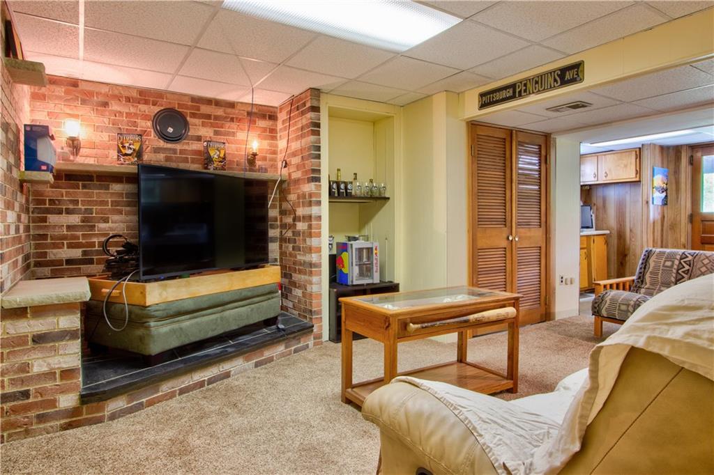 2076 Borland Road Pittsburgh, PA 15243 - Photo 16 of 24 Lower level game room with brick corner TV space. Walk out to patio and garage