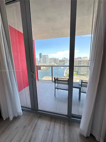 a bedroom with two beds and a large window