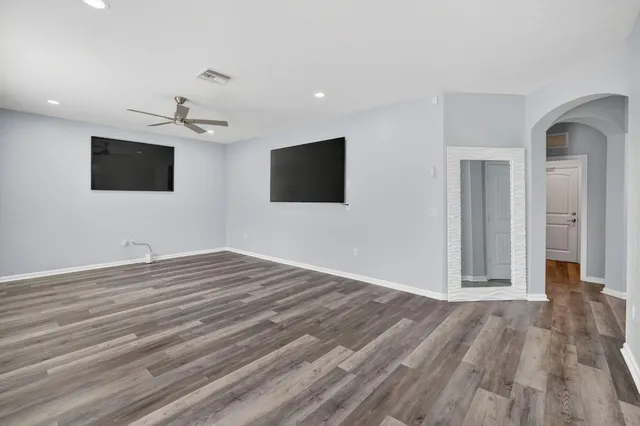 a view of empty room with wooden floor