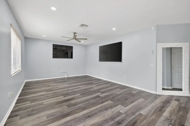 a kitchen with stainless steel appliances granite countertop wooden cabinets a stove top oven a sink and dishwasher with wooden floor