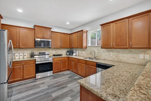 a bathroom with a tub a sink and mirror